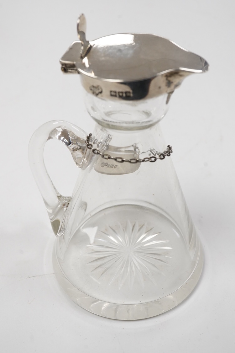 An Edwardian silver mounted glass whisky noggin and matching silver 'Whisky' label by Goldsmiths & Silversmiths Co Ltd, London, 1907, height 10.8cm.